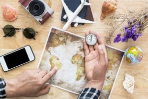 bucket list dreams of man holding compass and planing traveling